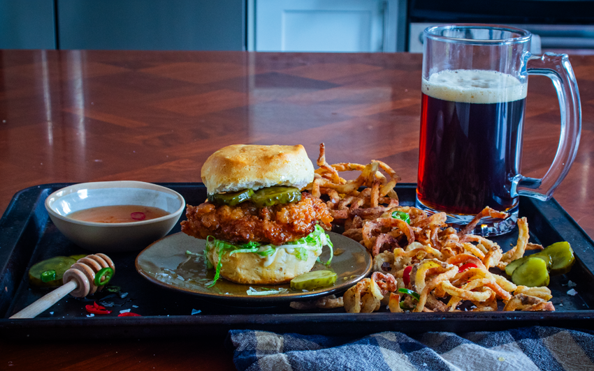 Hot chicken sandwich paired with beer